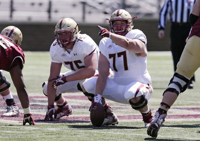 Boston College center Jon Baker (77) points towards the defense during a spring NCAA college football game in April. Baker will miss the remainder of the football season with a torn ACL in his right knee. [AP Photo/Charles Krupa]
