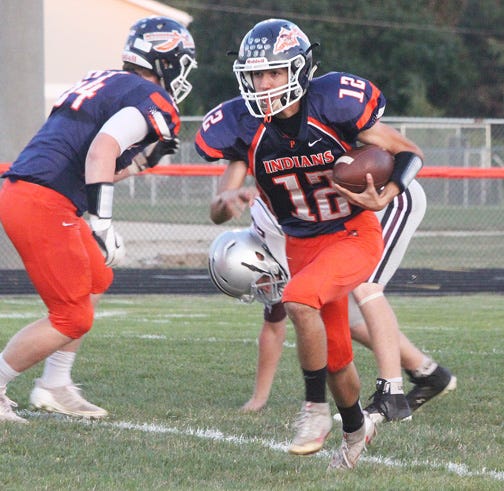 Pontiac quarterback Ethan Lee charges upfield during the Tribe’s 35-0 win Friday night.