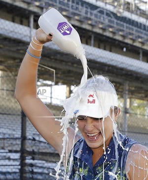 Lexi Thompson pours milk over her head after winning the Indy Women in Tech Championship golf tournament, Saturday, Sept. 9, 2017, in Indianapolis. (AP Photo/Darron Cummings)