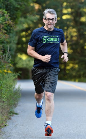 Derek Welch, who has lost 100 pounds in last year following gastric bypass surgery, has run several 5-kilometer races since. [T&G Staff/Christine Hochkeppel]