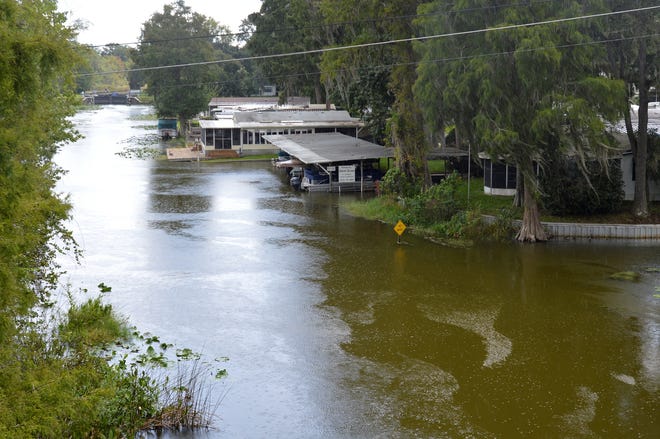 Homes in Bonfire Mobile Village line Haines Creek as rain falls before Hurricane Irma on Friday in Leesburg. [WHITNEY LEHNECKER / DAILY COMMERCIAL]