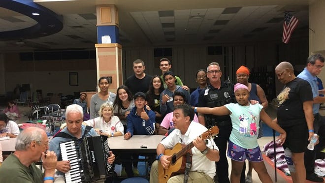 Shelter session: Frank Cerabino plays the accordion with harmonica player Don Klein, 77, of Boca Raton (left) in the cafeteria at Boca Raton High School Sept. 9.PHOTO Contributed