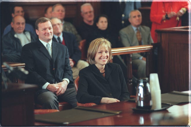 Patricia Lynch Harwood is joined by her husband, then-House Speaker John Harwood, rear, during her swearing in ceremony as a Superior Court magistrate in 2000. [The Providence Journal / John Freidah]
