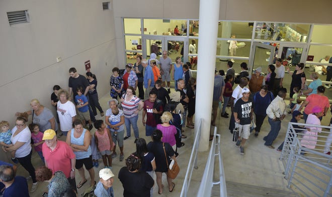 People stand in line for breakfast in the disaster shelter at Riverview High School in Sarasota, Fla. on Sunday, Sept. 10, 2017, in advance of Hurricane Irma. The full shelter is closed to new evacuees. [Mike Lang/Sarasota Herald-Tribune]
