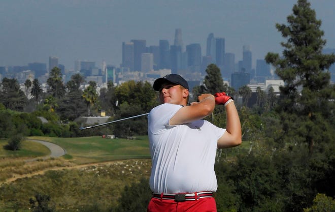 Braden Thornberry hits on the 13th hole during singles at the Walker Cup golf matches at Los Angeles Country Club, Sunday in Los Angeles. Behind him is the Los Angeles skyline. (AP Photo/Mark J. Terrill)