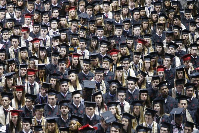 University of Alabama students participate in spring commencement exercises in May 2017 at Coleman Coliseum. The university estimates currently it will cost students about $30,000 to $48,600 on average to attend annually, depending on whether they come from Alabama or outside the state, and students employ different strategies for coping with the expenses.  [Staff Photo/Erin Nelson]