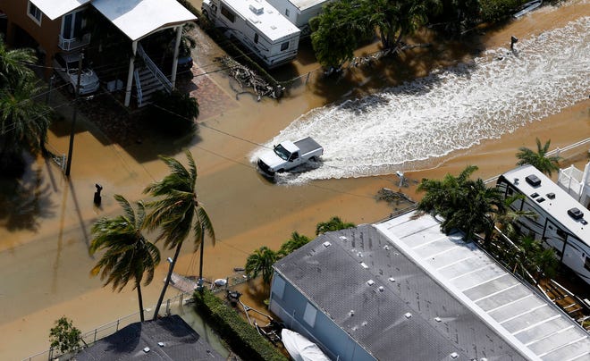 A truck drives through a flooded street in the aftermath of Hurricane Irma, Monday, Sept. 11, 2017, in Key Largo, Fla. (AP Photo/Wilfredo Lee)