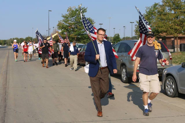 Lt. Gov. Adam Gregg and Bob Lyons, president of the March to the Capitol, lead the walkers. The second annual March to the Capitol started at Centennial Park in Waukee and made its way, 21 miles, to the Iowa State Capitol in Des Moines on Monday. PHOTO BY CLINT COLE/DALLAS COUNTY NEWS