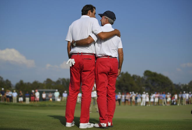 Scottie Scheffler, left, of the United States, embraces captain Spider Miller during singles at the Walker Cup golf matches at Los Angeles Country Club. [MARK J. TERRILL/AP PHOTO]