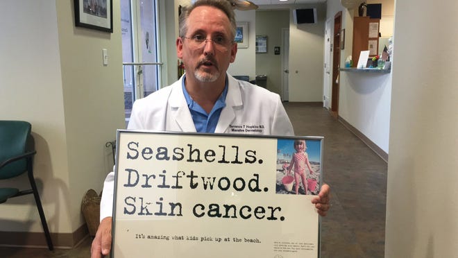 Dr. Terrence Hopkins, who owns Manatee Dermatology, tells parents of young children to cover them up at the beach because of the threat later in their lives of skin cancer from accumulated sun exposure. His mantra is, "Pale is the new tan. Tan is out." [RICHARD DYMOND/BRADENTON HERALD]