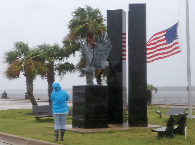 Blayne Kirby takes a photo of the Sept. 11th memorial at the Panama City Marina on Monday. All the Sept. 11 events planned for Bay County were canceled because of Hurricane Irma. [PATTI BLAKE/THE NEWS HERALD]