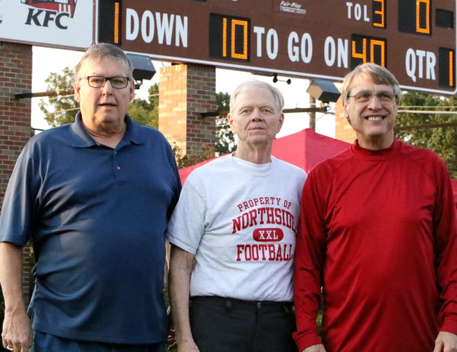 Doug Lowrey, from left, John Johnson and David Geren gather in front of the Mayo-Thompson Stadium scoreboard, Friday, Sept. 8, 2017, 50 years after winning the Arkansas State Football Championship in 1967. [JAMIE MITCHELL/TIMES RECORD]