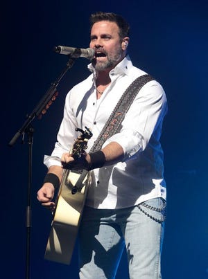 In this Jan. 17, 2013 file photo, Troy Gentry of the Country Music duo Montgomery Gentry performs on the Rebels On The Run Tour in Lancaster, Pa. Gentry, one half of the award-winning country music duo Montgomery Gentry, died Friday, Sept. 8, 2017, in a helicopter crash, according to a statement from the band's website. He was 50. The group was supposed to perform Friday at the Flying W Airport & Resort in Medford, N.J.