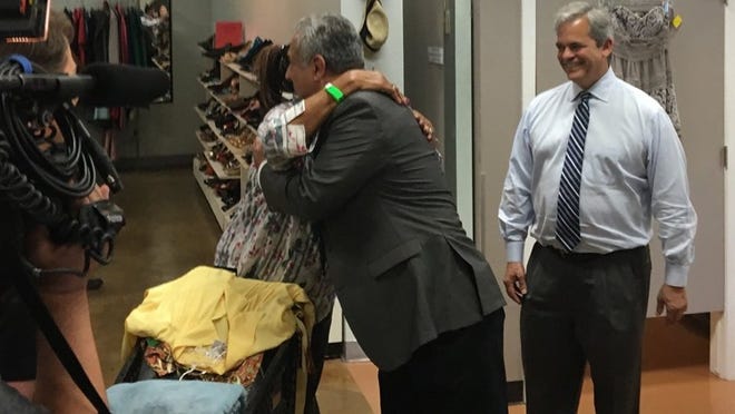 Pflugerville Mayor Victor Gonzales hugs a Beaumont resident displaced by Hurricane Harvey as Austin Mayor Steve Adler looks on at the Austin Disaster Relief Network headquarters in Austin. (Courtesy photo)