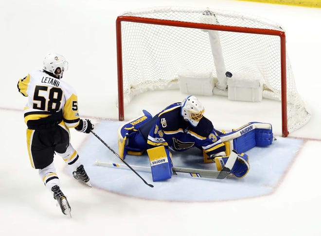 The Penguins’ Kris Letang (58) scores past St. Louis Blues goalie Jake Allen during a game last year in St. Louis