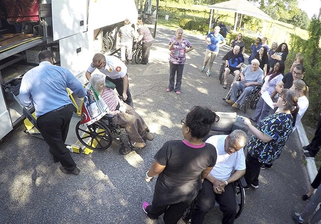 Staff members at Westwood Nursing and Rehabilitation Center in Fort Walton Beach, Fla., and firefighters from Fort Walton Beach Fire Department load Hurricane Irma evacuees, who had stayed at Westwood since last Saturday, onto a bus on Wednesday Sept. 13, 2017 to head back to the their facility in Mayo, Fla. (Nick Tomecek/Northwest Florida Daily News via AP)