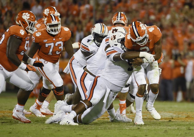 Clemson quarterback Kelly Bryant (2) is tackled by Auburn defensive lineman Derrick Brown (5) during the second half of a game on Saturday in Clemson, S.C. A team that averaged 40 points a game last season managed just two touchdowns at home against Auburn. Quarterback Kelly Bryant understands that must improve this week facing potent No. 14 Louisville and Heisman Trophy winner Lamar Jackson. [AP Photo / Rainier Ehrhardt]