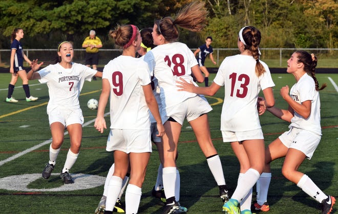 Portsmouth High School players, including Haley Dewsnap (7), Syd Ludes (9), Anna Smith (18) and Kylie Sullivan (13) mob Ginger Prevost after she scored the only goal in Tuesday's Division II soccer game against Bow in Portsmouth. [Mike Zhe/Seacoastonline]