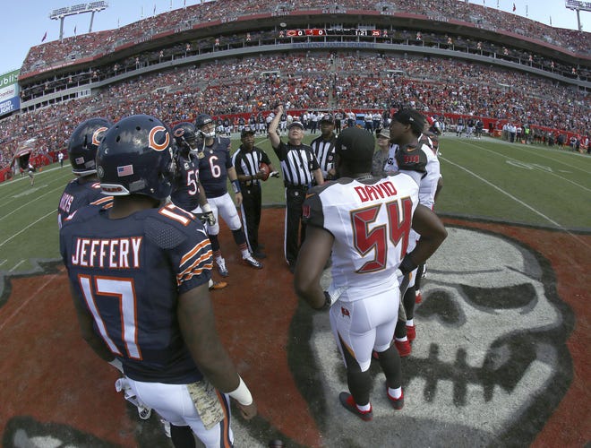 The Chicago Bears and Tampa Bay Buccaneers take part in the coin toss before a game, in Tampa this past November. There will be football in Tampa this weekend, and the Buccaneers will finally get to start a season delayed by Hurricane Irma's wrath. The Bucs announced that they will be able to host the Chicago Bears on Sunday, at Raymond James Stadium. CHRIS O'MEARA/THE ASSOCIATED PRESS