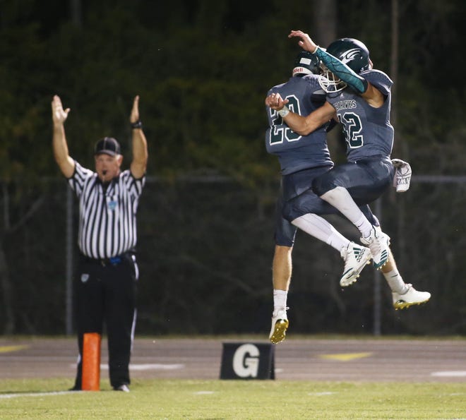 JM Allen (23) and Jayden Page (42) celebrate Allen's TD during South Walton vs Northview football. [MICHAEL SNYDER/DAILY NEWS]