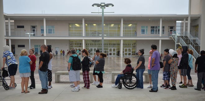 People stand in line for breakfast being served in the disaster shelter at Riverview High School in Sarasota, Fla. on Sunday in advance of Hurricane Irma. [Herald-Tribune staff photo / Mike Lang]