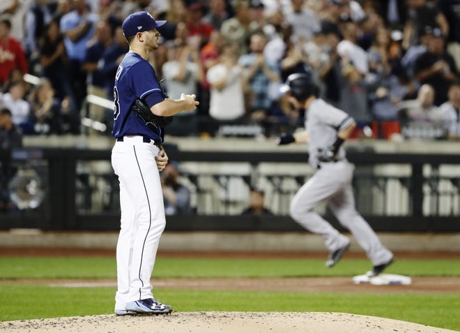 Rays starting pitcher Jake Odorizzi reacts as Yankees third baseman Todd Frazier runs the bases after hitting a three-run home run Monday at Citi Field in New York. [THE ASSOCIATED PRESS / FRANK FRANKLIN]