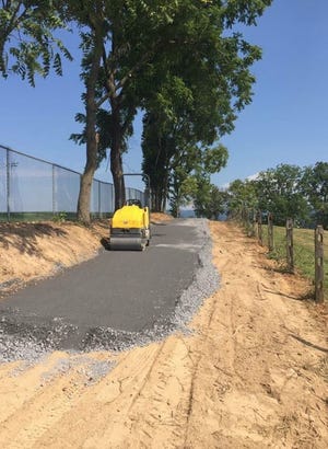 This photo was taken in late August as maintenance crews put down the foundation for the walking trail in Waynesboro. The project was completed Tuesday morning.