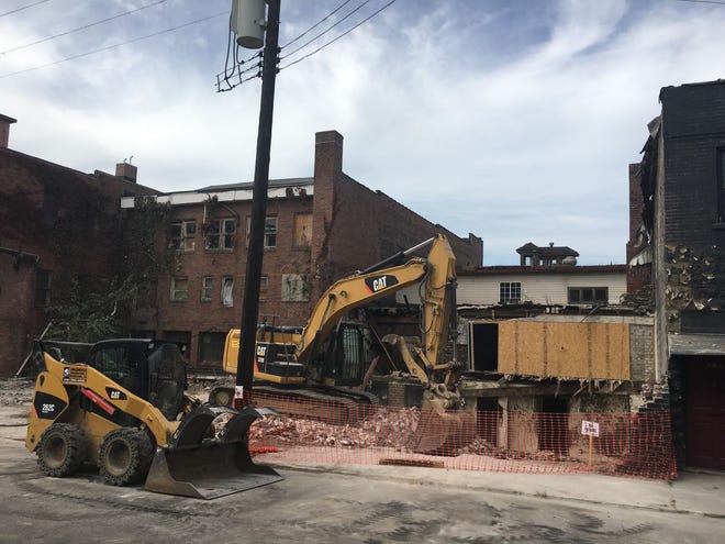 Demolition crews from Continental Construction and Demolition in Bethel Park continued work Tuesday on demolishing several buildings along Lawrence Avenue.