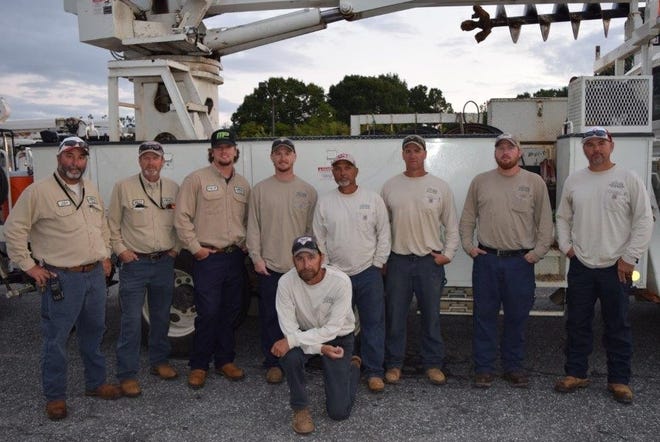 Linemen with the Gastonia Electric Department pause for a photo early Wednesday morning before setting off to help restore power for cities in Georgia and Florida hit by Hurricane Irma. Pictured from left are (standing) Jody Kiser, Matt Lambert, Phillip Potter, Brandon Phillips, Ray Miller, Andy Mabry, David Fredell and Brent Greene, and (kneeling) Patrick Isenhour. [Special to The Gazette]