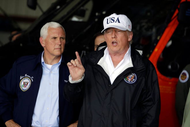 President Donald Trump and Vice President Mike Pence, left, participate in a briefing on the Hurricane Irma relief efforts, Thursday, Sept. 14, 2017, in Ft. Myers, Fla., at Southwest Florida International airport. (AP Photo/Evan Vucci)