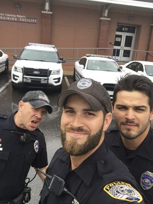 In this Sept. 10 photo provided by the Gainesville Police Department, officers, from left, John Nordman, Michael Hamill and Dan Rengering take a selfie in Gainesville. The photo was widely-shared on social media after the department posted it to Facebook with comments praising the officers good looks. [Gainesville Police Department via AP]