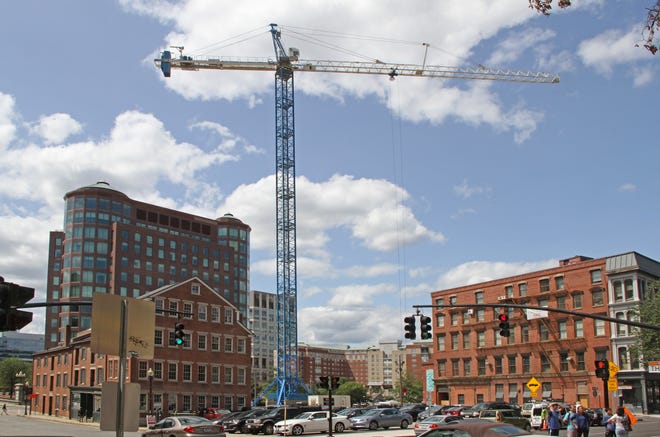 A 15-story crane stands at the intersection of North Main and Elizabeth streets in Providence, where a new housing complex is being built. [The Providence Journal/Sandor Bodo]