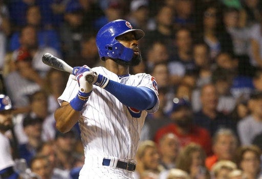 Chicago Cubs' Jason Heyward watches his three-run home run off New York Mets' Paul Sewald, also scoring Javier Baez and Albert Almora Jr., during the sixth inning of a baseball game Thursday, Sept. 14, 2017, in Chicago. (AP Photo/Charles Rex Arbogast)