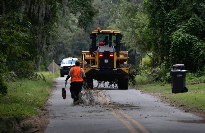 Chatham County crews clean up debris from Hurricane Irma in Pin Point on Thursday. (Dash Coleman/Savannah Morning News)