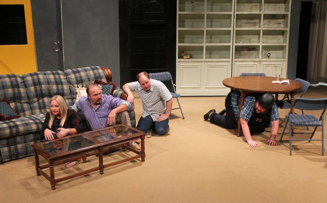 Richard (played by Cody Banning), right, cowers under the table in fear of Y2K while his unconvinced family þÄî Ruthie (played by Jill Ledbetter), from left, Bill (played by Michael Richardson) and Thomas (played by John Hall) þÄî humor him in a scene from "Making God Laugh" as presented by the Fort Smith Little Theatre. [PHOTO COURTESY FORT SMITH LITTLE THEATRE]