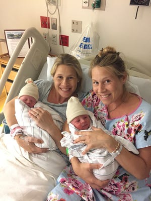 Rebecca Pistone, left, holds her baby girl, Andi Isabella Pistone, while Rachael McGeoch holds baby boy William Charles Bubenicek last month at Mount Auburn Hospital in Cambridge. The twin sisters gave birth within a day of each other. [Courtesy of the family]