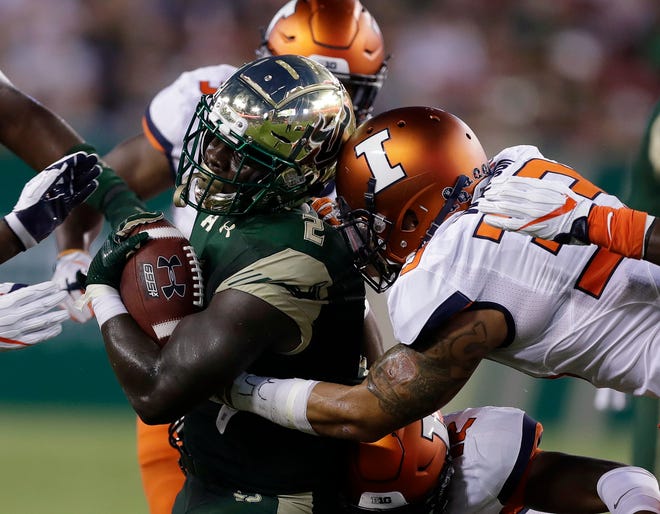 South Florida running back D'Ernest Johnson (2) is stopped by Illinois linebacker Tre Watson (33) after a run during the first quarter of an NCAA college football game Friday, Sept. 15, 2017, in Tampa, Fla. (AP Photo/Chris O'Meara)