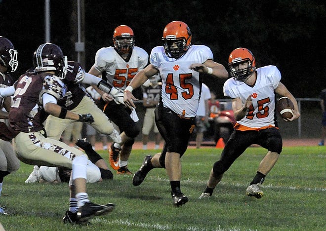 Marlborough junior captain Lou Vigeant (45) leads the way for senior captain Kevin Short (15) during a run in the first quarter of 28-8 win over Algonquin on Friday night in Northborough. [Daily News and Wicked Local Staff Phto/Art Illman]