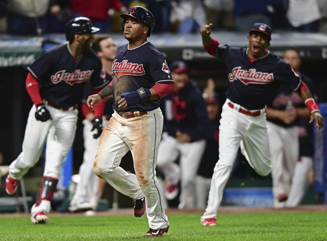 The Indians' Jose Ramire scores the game-winning run on a 10th-inning double by Jay Bruce during the 10th inning of Thursday's game against the Royals. The win was the 22nd straight for Cleveland, which forced extra innings with a run in the ninth off closer Kelvin Herrera. [ASSOCIATED PRESS]