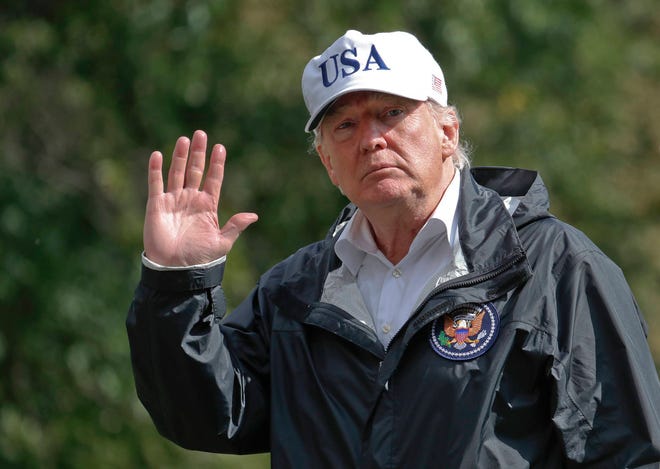 President Donald Trump waves as he arrives at the White House, Thursday, Sept. 14, 2017, in Washington. Trump is returning from Florida after viewing damage from Hurricane Irma. (AP Photo/Alex Brandon)