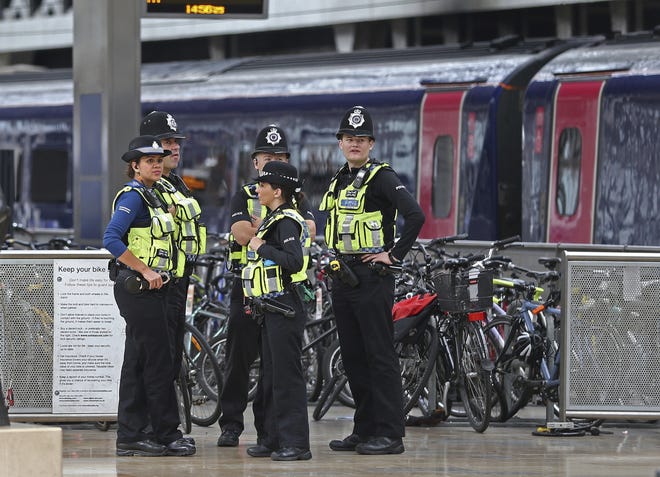 Police provide security at Paddington mainline train station in London, after a terrorist incident was declared at nearby Parsons Green subway station Friday. A bucket wrapped in an insulated bag caught fire on a packed London subway train early Friday, sending commuters running for safety at the height of the morning rush hour. [ANDREW MATTHEWS/PA via AP]