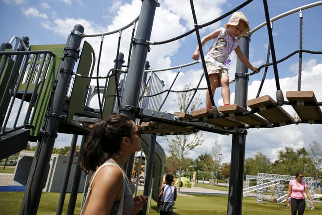 Anne Davis plays with Julia Brley, 4, her boyfriend's niece, at Depot Park in Gainesville on Friday. [Andrea Cornejo/ Staff photographer]