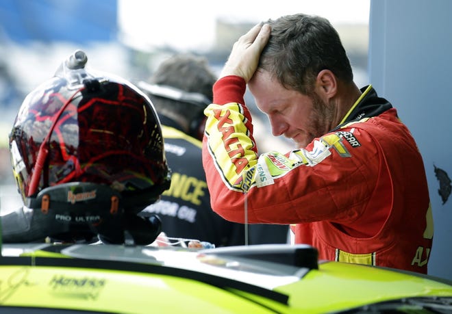 Dale Earnhardt Jr., checks his hair during the final practice for the NASCAR Cup Monster Energy Series auto race at Chicagoland Speedway in Joliet, Ill., Saturday, Sept. 16, 2017. (AP Photo/Nam Y. Huh)
