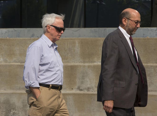 Gary Holcomb (left) leaves the U.S. Courthouse in Eugene after pleading guilty Friday as part of the Berjac Ponzi scheme case. (Chris Pietsch/The Register-Guard)