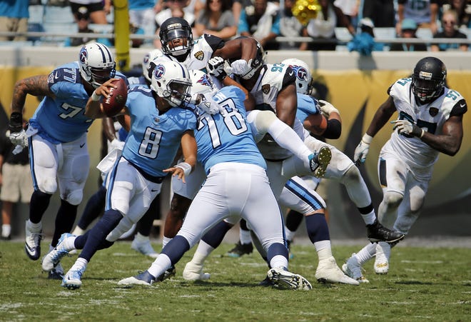 Tennessee Titans quarterback Marcus Mariota (8) scrambles as he is pressured by the Jacksonville Jaguars defense during the first half of an NFL football game, Sunday, Sept. 17, 2017, in Jacksonville, Fla. (AP Photo/Stephen B. Morton)