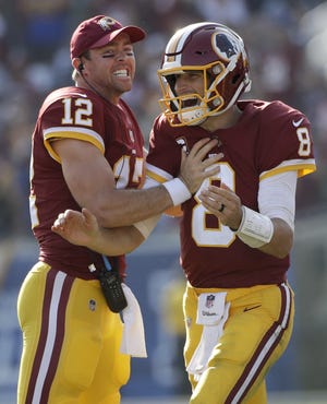 Washington Redskins quarterback Kirk Cousins, right, and quarterback Colt McCoy celebrate during the second half of an NFL football game against the Los Angeles Rams Sunday, Sept. 17, 2017, in Los Angeles. (AP Photo/Jae C. Hong)