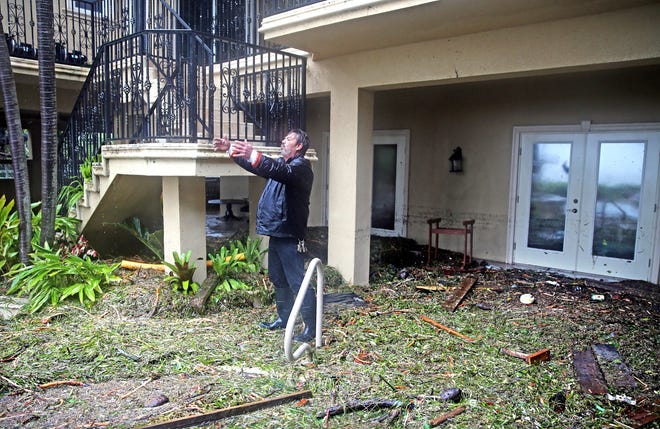 George Ramos explains the level of the surge in the house he is a caretaker for after Hurricane Irma swept a 10-foot surge onto the house on Sumerland Key in the Florida Keys. He said it "sound like a war" as the water battered the property. [CHARLES TRAINOR JR./MIAMI HERALD]