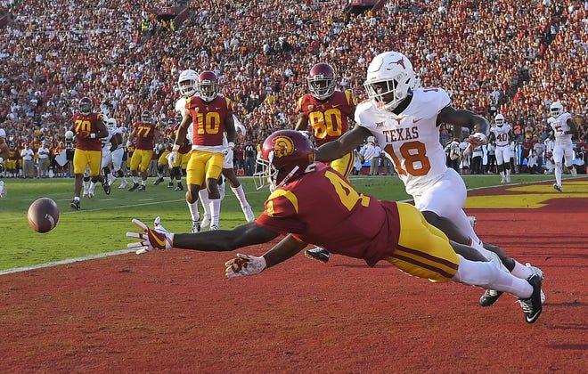 Southern California wide receiver Steven Mitchell Jr. left, can't reach a pass intended for him while under pressure from Texas defensive back Davante Davis. [MARK J. TERRILL/AP PHOTO]