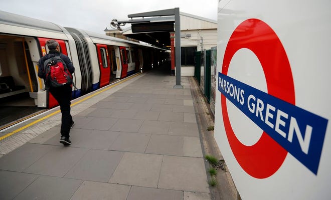 Travelers walk on the platform at Parsons Green tube station following Friday's incident on a tube at Parsons Green Station in London on Sunday. A manhunt is underway after an improvised explosive device was detonated on a crowded subway car, injuring at least 29 people.