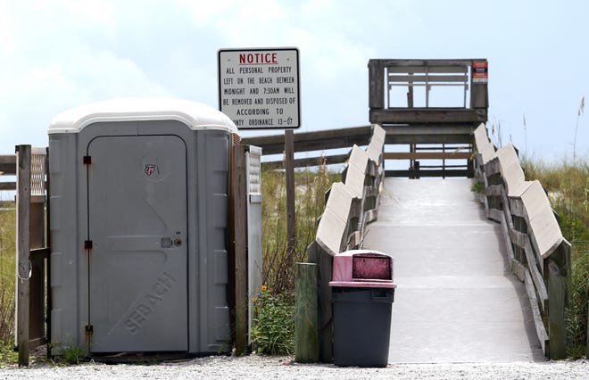 A portable toilet is positioned at beach access No. 4 on Okaloosa Island. [MICHAEL SNYDER/DAILY NEWS]
